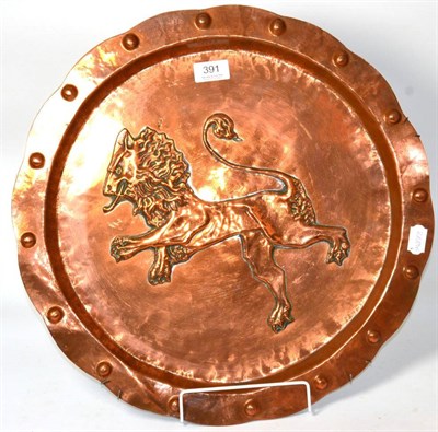 Lot 391 - A copper charger, decorated with a central lion