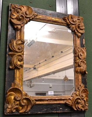 Lot 1042 - Gilt and black painted carved wood rectangular wall mirror, 64cm x 78cm