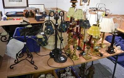 Lot 1137 - Fourteen decorative table lamps and candlesticks including brass baluster examples, parcel gilt...