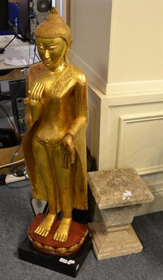 Lot 1150 - A Thai giltwood Buddha, on integral plinth, 127cm high, together with a stone composite...