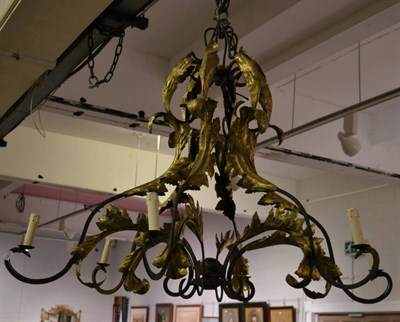 Lot 1153 - A wrought iron and parcel gilt metal foliate scrollwork six light electrolier, 99cm high and a pair