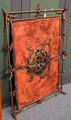 Lot 1154 - A Nordic influence leather panel screen, gilt metal frame, pierced and embossed central...