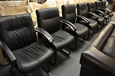 Lot 1169 - Seven black tubular and black leather office armchairs, modern, 65cm by 50cm by 97cm