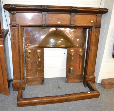 Lot 1175 - An Arts & Crafts oak fire surround with copper fire insert and oak curb