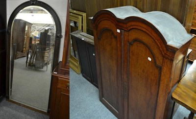 Lot 1189 - A panelled mahogany two door cupboard opening to reveal an arrangement of compartments and...