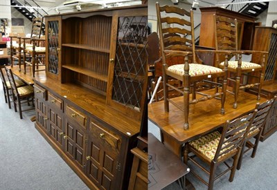 Lot 1192 - An oak dining suite comprising refectory table together with a set of six matching ladder back...