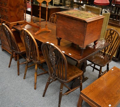 Lot 1194 - A 1920's carved oak side cabinet, an oak refectory table and five wheel back Windsor chairs (7)