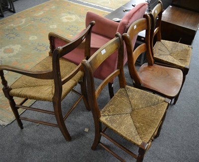 Lot 1199 - A set of three rush seat kitchen chairs; a similar example with solid seat and an upholstered...