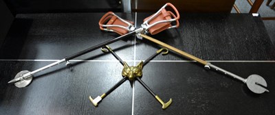 Lot 1200 - A pair of shooting sticks and a brass fox mask with crossed whips