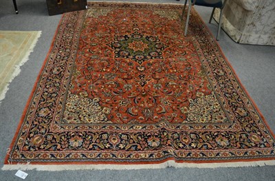 Lot 1206 - Saroukh Carpet, West Iran, the terracotta field of scrolling vines around a pole medallion...