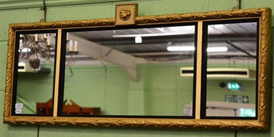 Lot 1238 - A triple pane overmantel mirror, with laurel borders and lion mask surmount