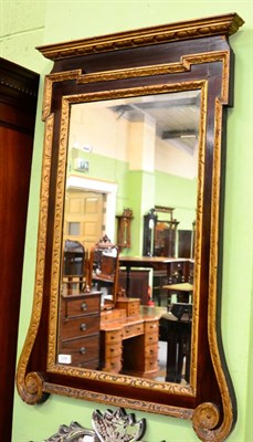 Lot 1245 - A 19th century parcel gilt mahogany mirror, with bevelled plate