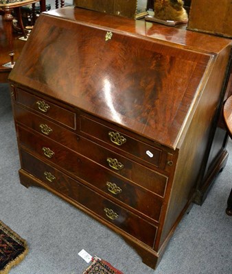 Lot 1274 - A reproduction George III mahogany bureau