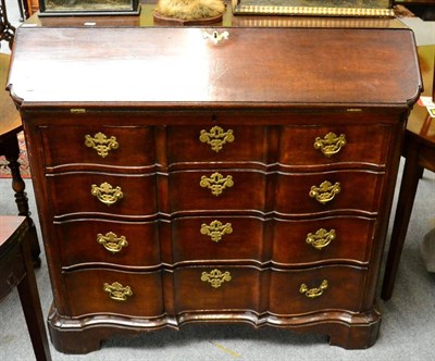 Lot 1278 - A 19th century oak serpentine fronted bureau