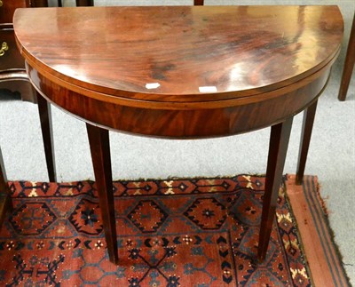 Lot 1281 - A 19th century mahogany demi lune fold over tea table