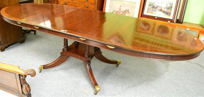 Lot 1286 - A reproduction mahogany and cross-banded extending dining table of oval form