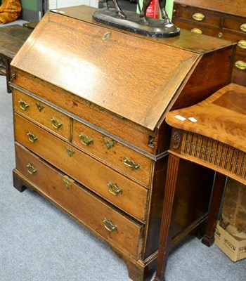 Lot 1289 - A George III oak bureau with fully fitted interior