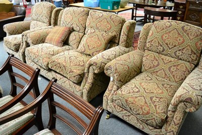 Lot 1291 - A Parker Knoll Oakham model three piece suite, modern, covered in multi-coloured floral fabric,...