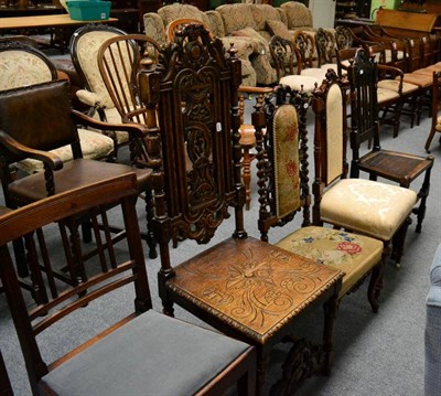 Lot 1312 - A carved oak hall chair and three similar chairs