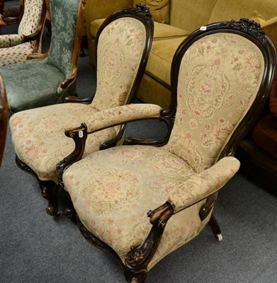 Lot 1316 - A Victorian carved mahogany gents open armchair together with a matching ladies chair