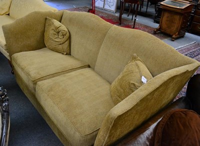 Lot 1320 - A feather filled two-seater knole sofa, modern, upholstered in yellow fabric, with serpentine...