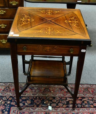 Lot 1322 - A 19th century inlaid rosewood envelope card table with a gallery shelf stretcher