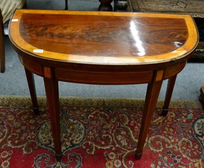 Lot 1324 - An inlaid and cross banded demi lune fold over card table (a.f.)