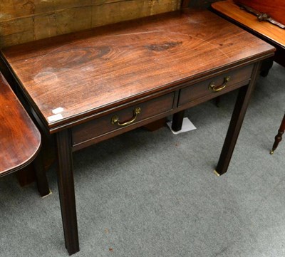 Lot 1333 - A 19th century mahogany fold over tea table fitted with two drawers