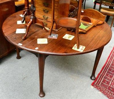 Lot 1344 - A George III mahogany gateleg table on pad feet