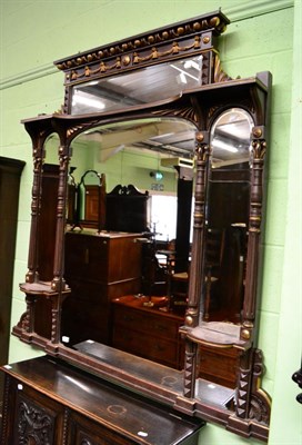 Lot 1365 - A parcel gilt simulated rosewood sectional over mantle mirror decorated with swags and fluted...