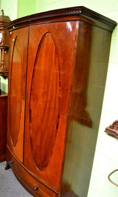 Lot 1367 - A mahogany double wardrobe fitted with a base drawer