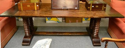 Lot 1385 - An oak refectory style dining table, 20th century, of plank top construction with spiral turned...