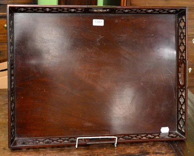 Lot 1387 - A mahogany tray with pierced gallery