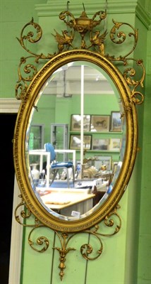 Lot 1390 - An oval gilt framed mirror in the Adams taste with conforming bevelled plate