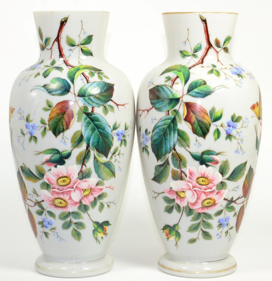 Lot 5 - A pair of Victorian enamel painted opaque glass vases decorated with butterflies and flowers