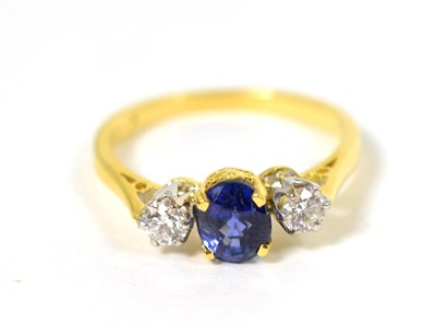 Lot 100 - An 18 carat gold sapphire and diamond three stone ring, an oval cut sapphire in a claw setting,...