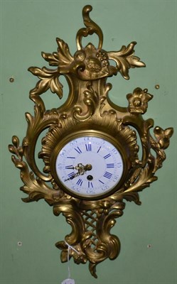 Lot 131 - A gilt metal cartel wall timepiece