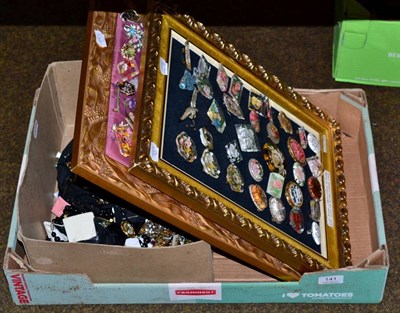 Lot 141 - A quantity of assorted circa 1950s Lucite brooches pinned on two gilt frames, many reverse painted