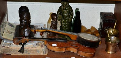 Lot 163 - A shelf of ornamental items including a Stainer violin (a.f.); a banjolele; two bronze pestles...