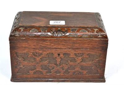 Lot 207 - A carved oak two division tea caddy, with fitted interior