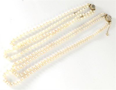 Lot 231 - A double strand graduated cultured pearl necklace, with a 9 carat gold blue zircon and pearl...