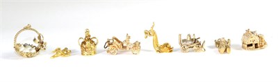 Lot 234 - Eight various 9 carat gold charms, including; a water wheel, a classic car, a teddy bear,...