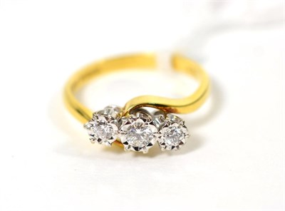 Lot 238 - An 18 carat gold diamond three stone ring, graduated round brilliant cut diamonds in illusion...