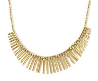 Lot 253 - A fringe necklace, of graduated alternating plain and engine turned bar links, to a beaded...