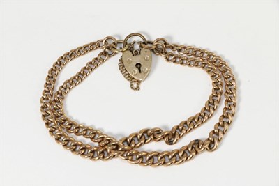 Lot 265 - A double strand graduated curb link bracelet, with a padlock claps, length 19cm, stamped '9 375'