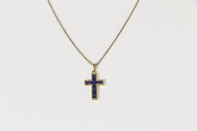 Lot 266 - A 9 carat gold sapphire cross pendant, inset with calibré cut sapphires, measures 2.5cm by...