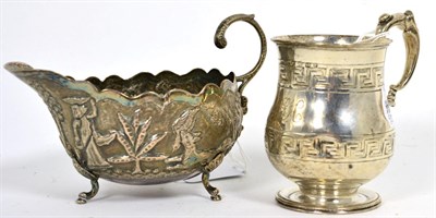 Lot 288 - An Indian white metal sauce boat and a silver christening mug (2)