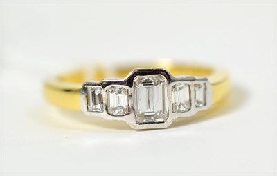 Lot 324 - An 18 carat gold octagonal cut diamond ring, five graduated diamonds in rubbed over settings,...