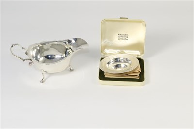 Lot 337 - A Georgian style silver sauce boat, marks rubbed; and a small silver Armada dish, Comyns,...