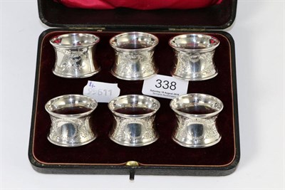 Lot 338 - A set of six silver napkin rings, London 1909, in a fitted case, (no initials)